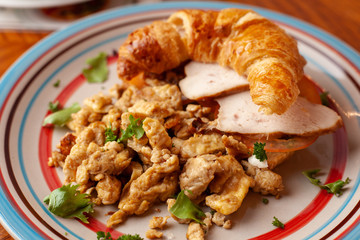 Lush croissant with chicken, soft cream cheese and scramble