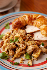 Lush croissant with chicken, soft cream cheese and scramble