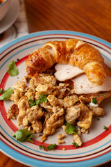 Lush croissant with chicken, soft cream cheese and scramble