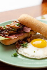 Ciabatta with oyster mushrooms, ham and fried egg for breakfast