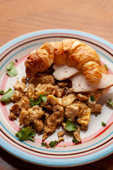 Lush croissant with chicken, soft cream cheese and scramble
