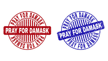 Grunge PRAY FOR DAMASK round stamps isolated on a white background. Round seals with grunge texture in red and blue colors.