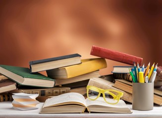 Books and glasses on  table  background,close up