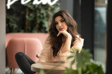 Young girl relaxing in cafe.
