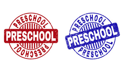 Grunge PRESCHOOL round stamp seals isolated on a white background. Round seals with grunge texture in red and blue colors. Vector rubber imitation of PRESCHOOL tag inside circle form with stripes.