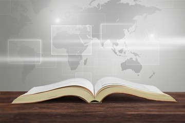 Stack of books with laptop on table