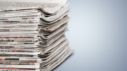 Pile of newspapers on white background