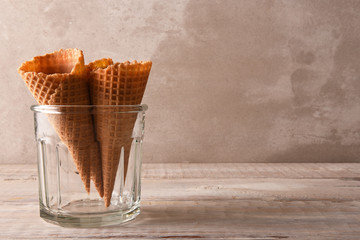 Closeup of three ice cream cones in a large glass