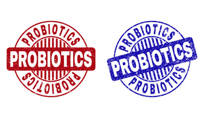 Grunge PROBIOTICS round stamp seals isolated on a white background. Round seals with grunge texture in red and blue colors. Vector rubber imprint of PROBIOTICS text inside circle form with stripes.