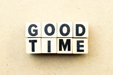 Letter block in word good time on wood background