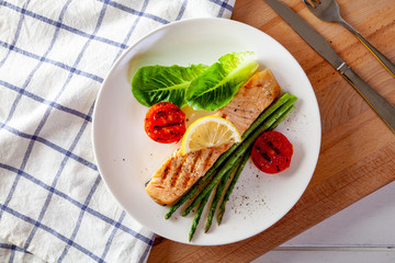 Roasted salmon steak with asparagos tomatoes  with fresh vegetable.
