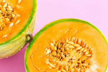 Yellow cantaloupe melon on pink background