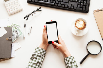 Business person using mobile phone on business table