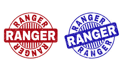 Grunge RANGER round stamp seals isolated on a white background. Round seals with grunge texture in red and blue colors. Vector rubber overlay of RANGER text inside circle form with stripes.