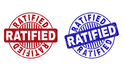 Grunge RATIFIED round stamp seals isolated on a white background. Round seals with grunge texture in red and blue colors. Vector rubber imitation of RATIFIED label inside circle form with stripes.