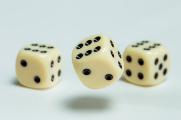 Two dice lie on a table. A dice falls. Concept gambling.