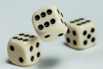 Two dice lie on a table. A dice falls. Concept gambling.