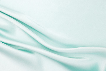 The texture of the satin fabric of blue color for the background