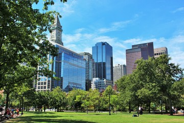 Christopher Columbus Park in Boston, MA on a sunny summer day with Boston skyline and clock tower in the background