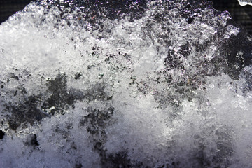 Macro abstract view of grungy melting snow on an asphalt surface