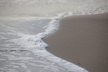 Bubble Foam of the Sea Wave on the Beach and Fine Sand, Summer Holidays