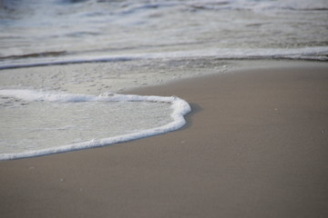 Bubble Foam of the Sea Wave on the Beach and Fine Sand, Summer Holidays