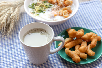 Breakfase meal. Congee or Rice porridge minced pork, boiled egg with soy milk and Chinese deep fried double dough stick