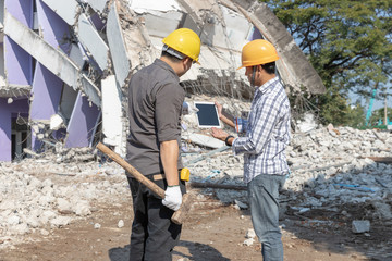 Engineer architect and worker operation control demolish old building.