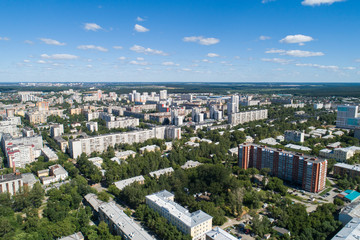 Fototapeta premium Top down aerial drone image of a Ekaterinburg city in the midst of summer, backyard turf grass and trees lush green.