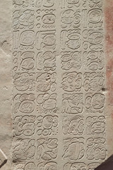 Base relief stone carving with Mayan inscription, pre-Columbian Maya civilization.