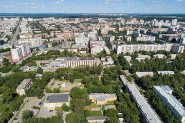 Obraz premium Top down aerial drone image of a Ekaterinburg city in the midst of summer, backyard turf grass and trees lush green.