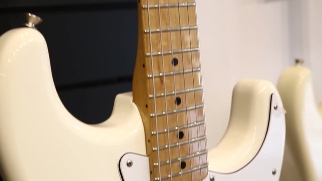 Professional white electric guitar, bottom-up movement