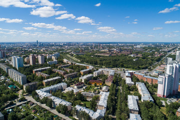 Fototapeta na wymiar Top down aerial drone image of a Ekaterinburg city and plant in the midst of summer, backyard turf grass and trees lush green.