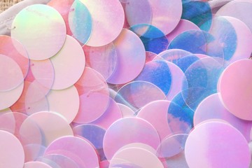 Sequins macro background.large sequins in blue and pink colors.Fabric with sequins in pastel tone.ridescent fabric.Scales background.  Background with shiny sequins.Texture scales with Sequins 