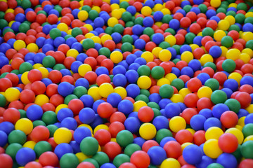 Fototapeta na wymiar Ball color for child. Many colorful plastic balls. Child room. Colored plastic toy balls of different color for the children's pool dry. View from afar. Picture background, wallpaper, texture.