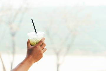Man holding matcha green tea ice. copy space for text.