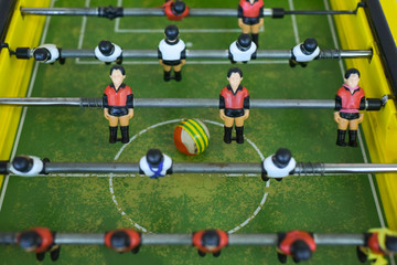 Table football in the entertainment center. Close-up image of plastic players in a football game.