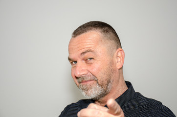 Charismatic middle-aged man pointing a finger