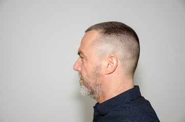 Profile portrait of a man with short haircut