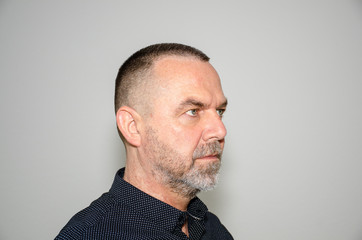 Profile portrait of a man with short haircut
