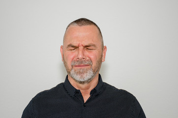 Obraz premium Upset man with closed eyes in anguish