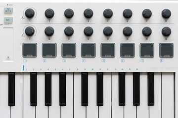 MIDI keyboard with pads and faders.