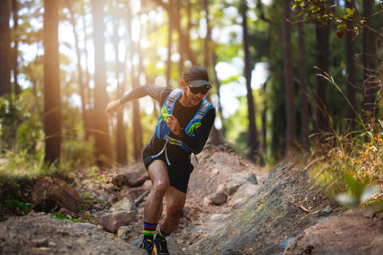 A man Runner of Trail . and athlete's feet wearing sports shoes for trail running in the forest