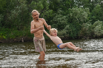 father teaching his little son to swim, they are happy.