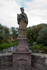 Obraz premium Tauberrettersheim Germany, Tauber Bridge statue of St. Nepomuk statue, copy of the original from 1716. Translation Latin to English; Saint Nepomuk 1716