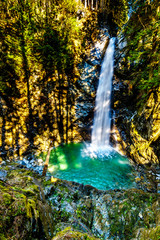 Fototapeta na wymiar The turquoise waters of Cascade Falls in Cascade Falls Regional Park between the towns of Mission and Deroche in British Columbia, Canada