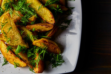 pleasant to the taste home-made fried potatoes with aromatic spices. home kitchen. Still life.