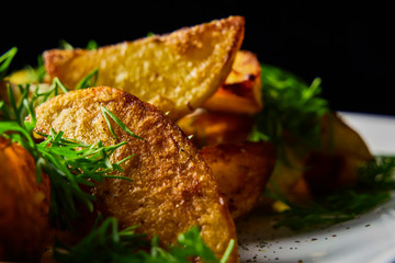 pleasant to the taste home-made fried potatoes with aromatic spices. home kitchen. Still life.