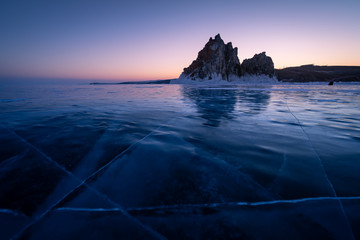 Shaman rock, sacred stone in Olkhon island in a beautiful morning sunrise, Baikal lake in winter,...