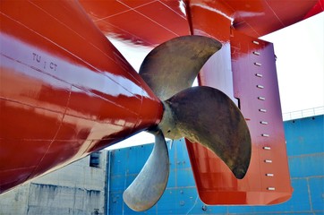 Cargo ship in the dry dock, view on the propeller. 